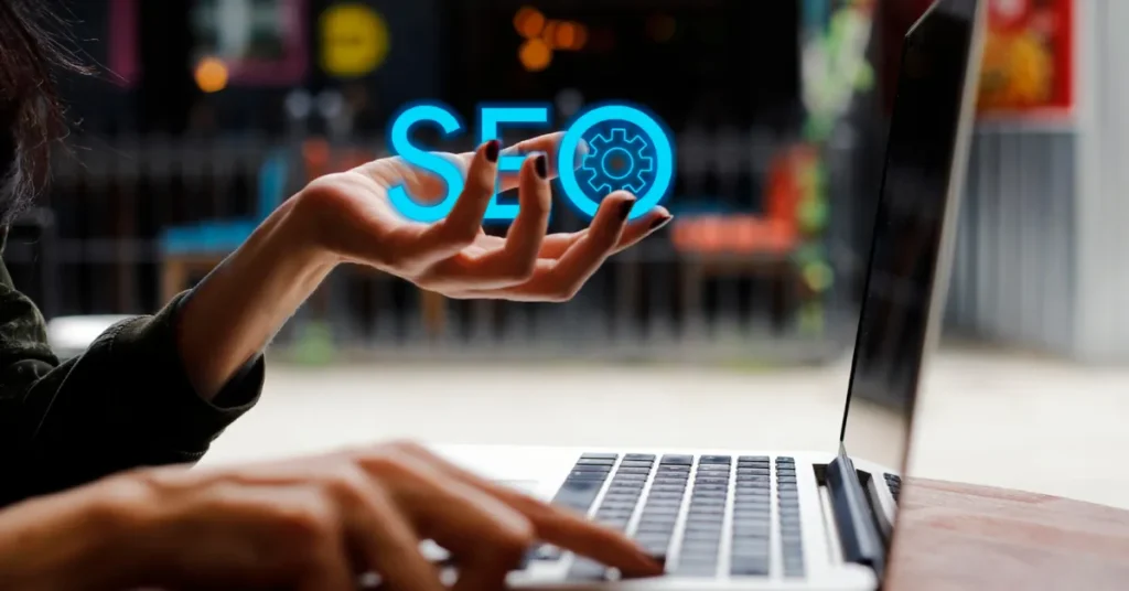 SEO concept displayed with hand and laptop